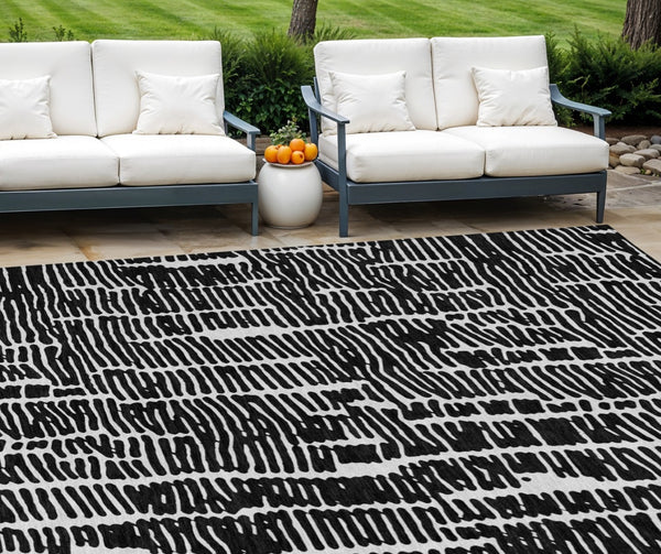 HomeRoots 5' Durable Black and Ivory Abstract Area Rug – Stylish, Washable Design for Indoor and Outdoor Use 8' X 10' 588495