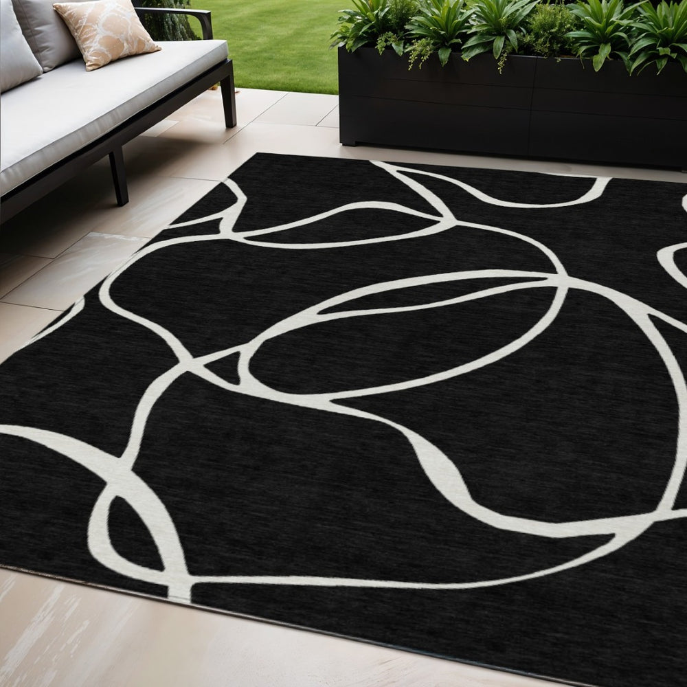 HomeRoots 5' Black and Ivory Abstract Area Rug - Stylish, Durable Design for Indoor and Outdoor Spaces 5' X 8' 597458