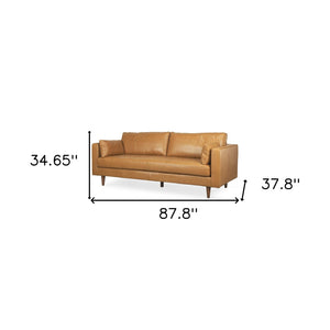 HomeRoots 88" Premium Tan Leather Sofa with Toss Pillows & Elegant Brown Legs for Modern Living Spaces 607329