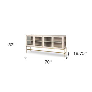 HomeRoots 70" Luxurious Gold and White Solid Wood Sideboard with Soft-Close Doors and Glass Shelving Storage 611016