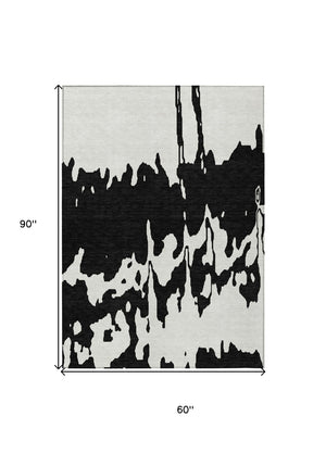 HomeRoots 5' Versatile Black and Ivory Abstract Indoor Outdoor Rug - Washable, Durable, Stylish for Any Space 5' X 8' 613615