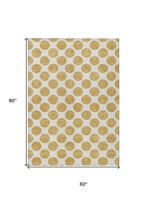 HomeRoots 5' Gold and Ivory Polka Dot Indoor Outdoor Area Rug - Durable, Washable, Non-Slip for Any Space 5' X 8' 614894
