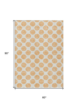 HomeRoots 5' Peach and Ivory Polka Dot Washable Area Rug for Indoor & Outdoor High-Traffic Spaces 5' X 8' 614930