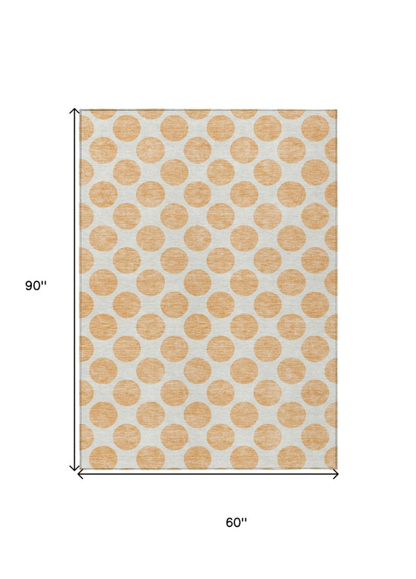 HomeRoots 5' Peach and Ivory Polka Dot Washable Area Rug for Indoor & Outdoor High-Traffic Spaces 5' X 8' 614930