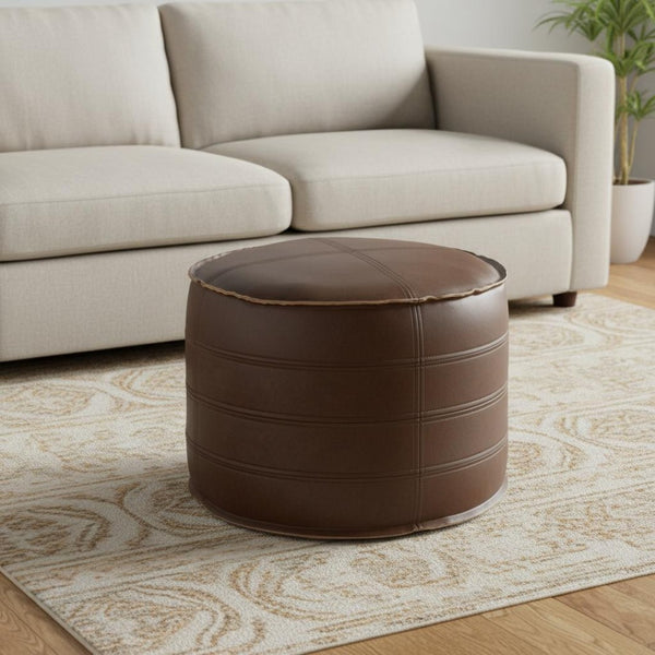 HomeRoots 20" Brown Faux Leather Round Pouf Ottoman - Stylish Versatile Footrest & Extra Seating for Any Room 638522