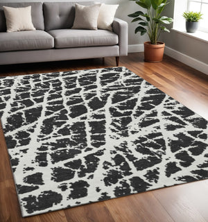HomeRoots 5' X 8' Black And Ivory Abstract Area Rug - Washable, UV Protected, Stylish & Durable for Families 646520