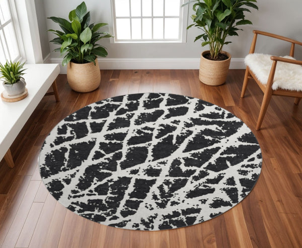 HomeRoots 8' Black And Ivory Abstract Washable Round Rug - Stylish, Durable & UV-Protected for Busy Homes! 646521