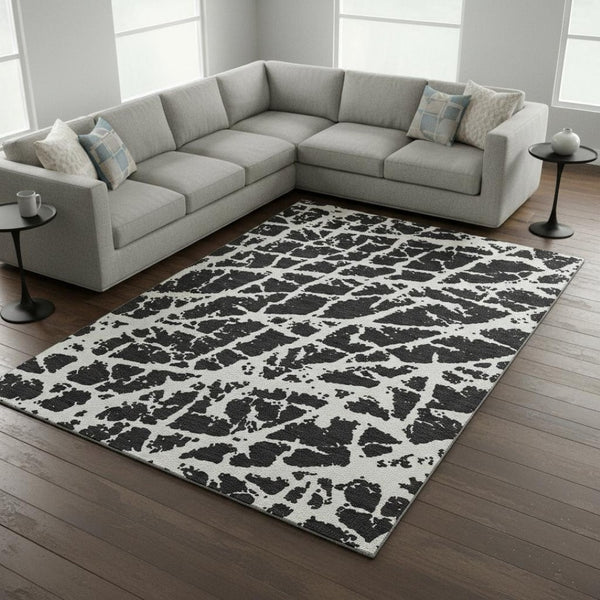 HomeRoots 8' X 10' Modern Black and Ivory Abstract Washable Area Rug with UV Protection for High-Traffic Homes 646522