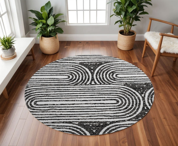 HomeRoots 8' Black And Ivory Geometric Round Rug - Washable, UV-Protected, Modern Design for High-Traffic Areas 648223