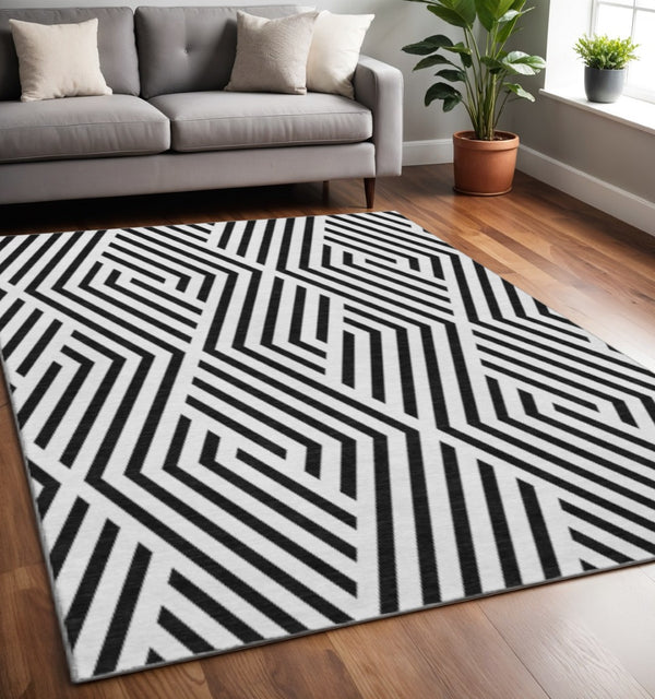 HomeRoots 5' X 8' Black and Ivory Geometric Area Rug - Stylish, Washable, UV-Protected, Perfect for High-Traffic Spaces 648516