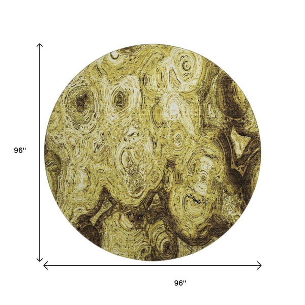 HomeRoots 8' Gold and Chocolate Abstract Round Rug - Washable, UV-Protected, Durable for High Traffic Areas 650155