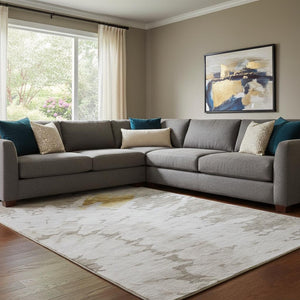 HomeRoots 9' X 12' Abstract Washable Area Rug in Taupe, Gold & Ivory with UV Protection for Modern Spaces 651315