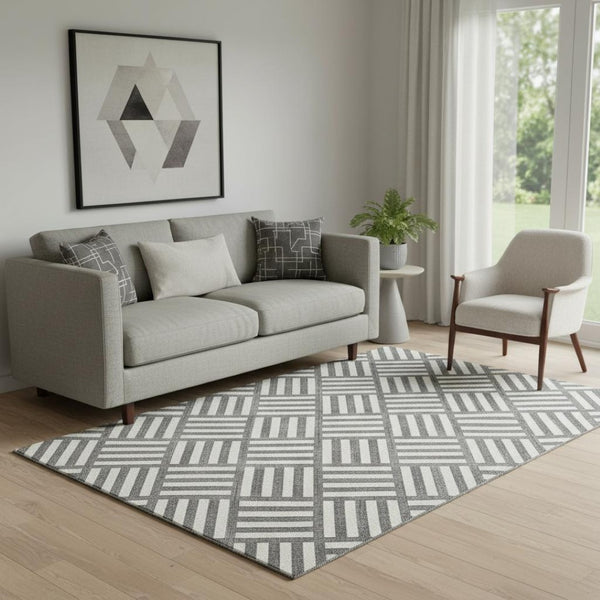 HomeRoots 5' X 8' Black And Ivory Geometric Washable Area Rug - Stylish, UV-Protected, Durable for Busy Spaces 652325