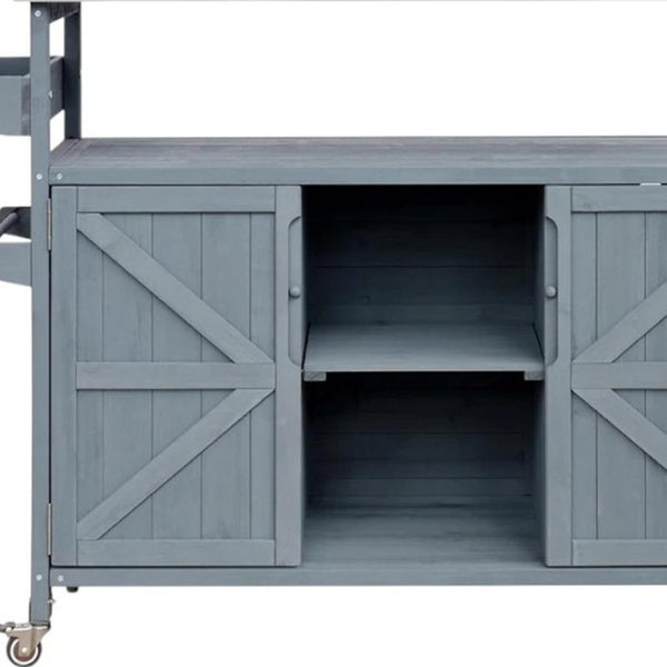 HomeRoots 50" Light Blue Wood Barn Door Rolling Kitchen Island with Storage - Rustic Charm & Versatile Design 654072