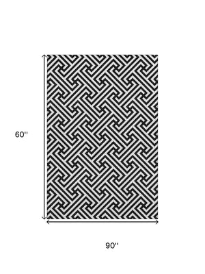 HomeRoots 5' X 8' Black And Ivory Geometric Area Rug - Durable, Washable, UV-Protected for High-Traffic Spaces 661781