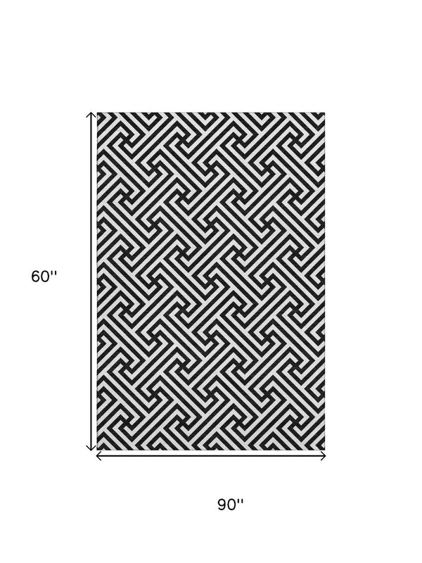 HomeRoots 5' X 8' Black And Ivory Geometric Area Rug - Durable, Washable, UV-Protected for High-Traffic Spaces 661781