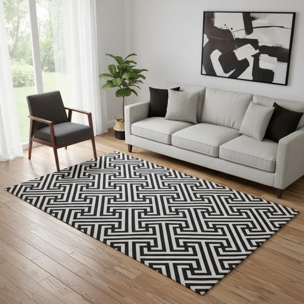 HomeRoots 5' X 8' Black And Ivory Geometric Area Rug - Durable, Washable, UV-Protected for High-Traffic Spaces 661781