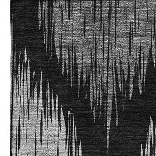 HomeRoots 5' X 8' Modern Black and Ivory Ikat Washable Area Rug with UV Protection for High-Traffic Spaces 667451