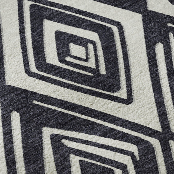 HomeRoots 8' Black and Ivory Geometric Round Rug - Washable, UV-Protected, Stain-Resistant for Modern Spaces 668382
