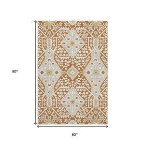 HomeRoots 5' X 8' Floral Area Rug in Rust, Beige & Gold - Washable, UV-Protected, Stylish & Durable Design 668557