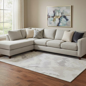 HomeRoots 10' X 14' Ivory and Beige Abstract Washable Area Rug - UV Protected, Soft, Stylish, Family-Friendly 668669