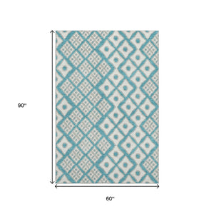 HomeRoots 5' X 8' Teal and Ivory Geometric Area Rug – Washable, UV-Protected, Ideal for High-Traffic Spaces 668762