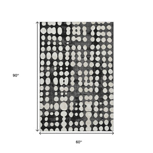 HomeRoots 5' X 8' Black And Ivory Polka Dot Washable Area Rug - Durable, UV-Protected, Ideal for Any Room 669092