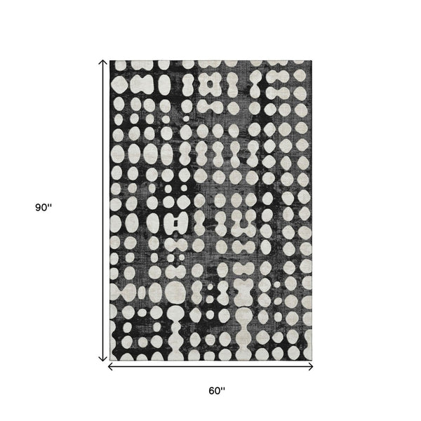 HomeRoots 5' X 8' Black And Ivory Polka Dot Washable Area Rug - Durable, UV-Protected, Ideal for Any Room 669092