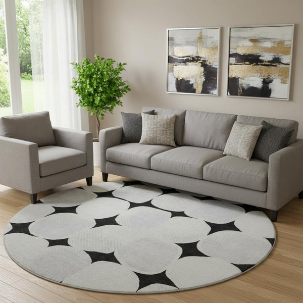 HomeRoots 8' Black and Ivory Abstract Geometric Washable Round Rug - Durable, Stylish & UV Resistant Design 669165