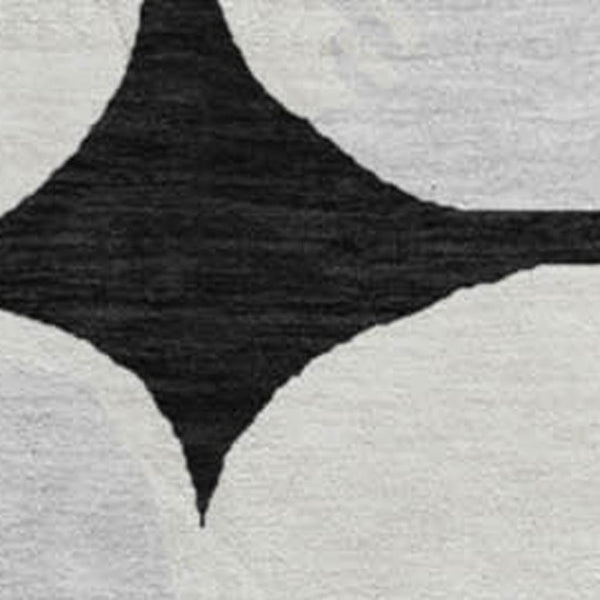 HomeRoots 8' Black and Ivory Abstract Geometric Washable Round Rug - Durable, Stylish & UV Resistant Design 669165