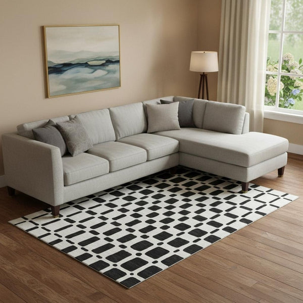 HomeRoots 9' X 12' Modern Black and Ivory Geometric Washable Area Rug with UV Protection for Busy Homes 669257