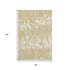 HomeRoots 5' X 8' Gold and Ivory Animal Print Area Rug - Washable, UV Protected, Stylish and Durable Design 669434