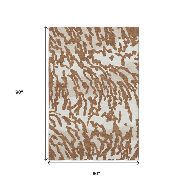 HomeRoots 5' X 8' Versatile Washable Animal Print Rug in Rust and Ivory - Stain Resistant, UV Protected, Durable 669464