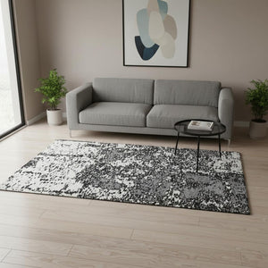 HomeRoots 5' X 8' Black and Ivory Abstract Area Rug - Stylish, Washable, UV Protected for Modern Spaces 675206