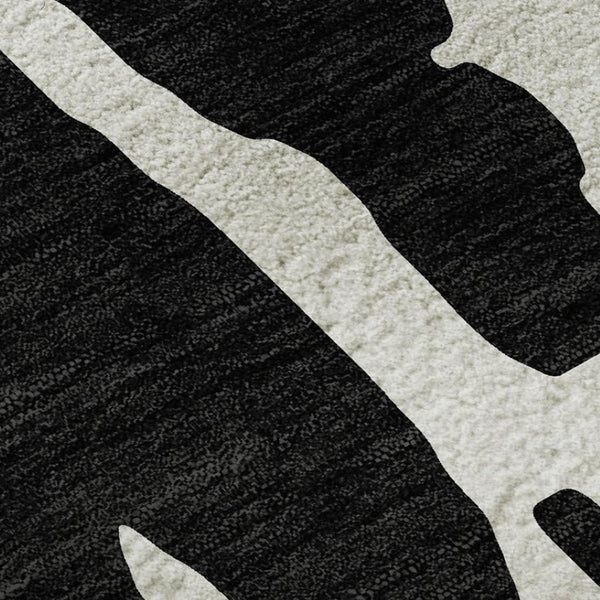 HomeRoots 5' X 8' Black And Ivory Abstract Area Rug - Washable, Stain Resistant, UV Protected for Versatile Spaces 676112