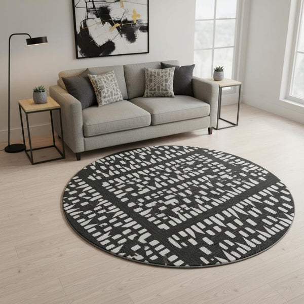HomeRoots 8' Washable Black and Ivory Geometric Round Rug with UV Protection for Modern Living Spaces 676251