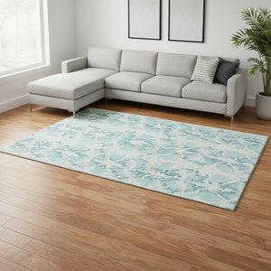 HomeRoots 10' X 14' Teal & Ivory Abstract Washable Area Rug with UV Protection for Modern Living Spaces 676692