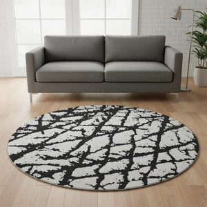 HomeRoots 8' Black And Ivory Abstract Round Rug - Washable, UV Protected, Durable Design for Modern Homes 676809