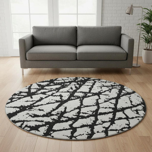 HomeRoots 8' Black And Ivory Abstract Round Rug - Washable, UV Protected, Durable Design for Modern Homes 676809