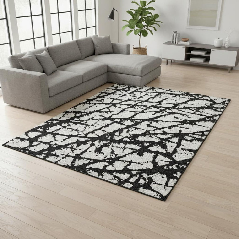 HomeRoots 9' X 12' Black And Ivory Abstract Rug - Washable, UV Protected, Durable Design for High-Traffic Areas 676811