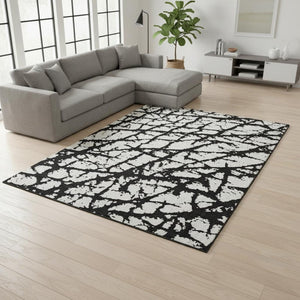 HomeRoots 9' X 12' Black And Ivory Abstract Rug - Washable, UV Protected, Durable Design for High-Traffic Areas 676811