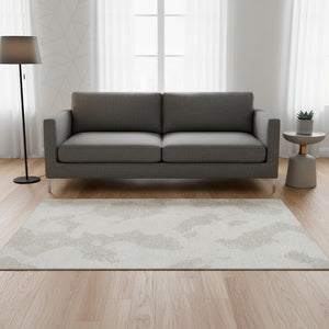 HomeRoots 5' X 8' Abstract Ivory and Beige Washable Area Rug with UV Protection for Modern Living Spaces 677036
