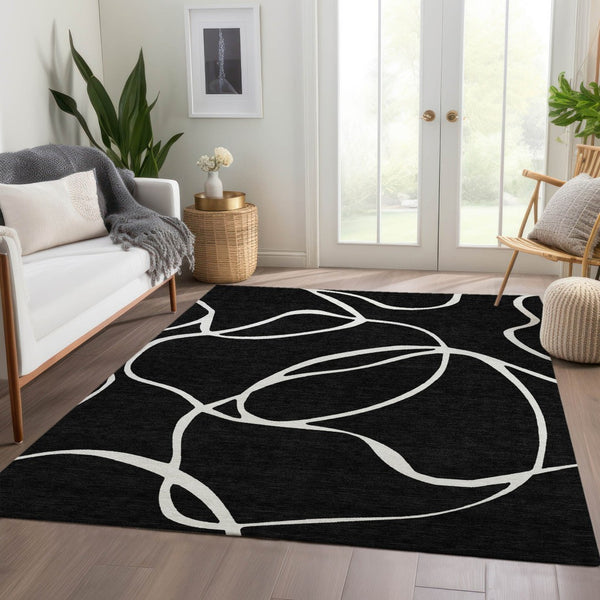 HomeRoots 8' X 10' Black and Ivory Abstract Area Rug - Washable, UV Protected, Perfect for High-Traffic Rooms! 678620
