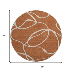 HomeRoots 8' Rust and Beige Abstract Round Rug - Washable, UV Protected, Durable for High-Traffic Areas! 678667