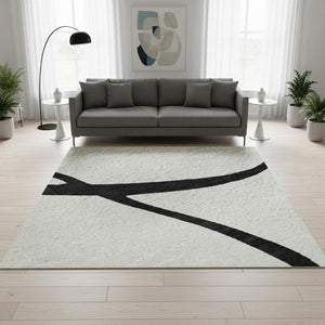 HomeRoots 5' X 8' White and Black Abstract Area Rug - Washable, UV Protected, Stylish for High-Traffic Spaces 678690