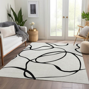 HomeRoots 5' X 8' White and Black Abstract Area Rug - Washable, UV Protected, Stylish for High-Traffic Spaces 678690