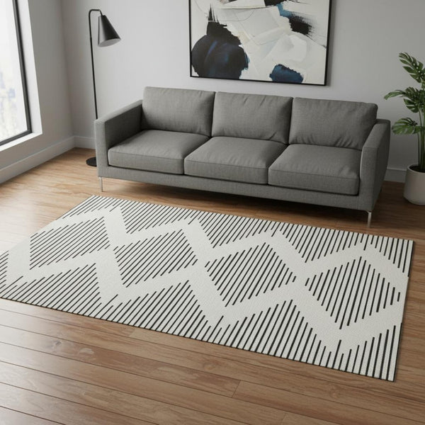 HomeRoots 5' X 8' Ivory And Black Geometric Area Rug - Stylish, Washable, UV Protected for Modern Spaces 679740
