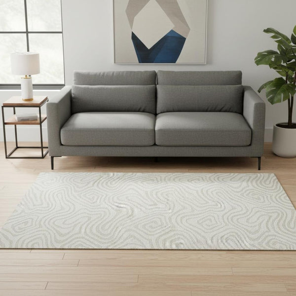 HomeRoots 5' X 8' Ivory and Beige Abstract Area Rug - Washable, Stain Resistant, UV Protected for Families 680093