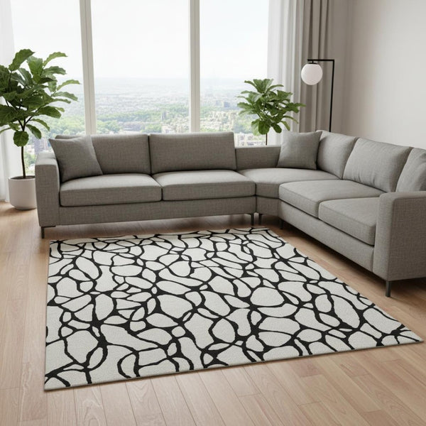 HomeRoots 10' X 14' Ivory and Black Washable Geometric Area Rug with UV Protection for Modern Spaces 680331