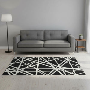 HomeRoots 5' X 8' Black And Ivory Geometric Area Rug - Stylish, Washable, UV-Protected for High-Traffic Spaces 681571